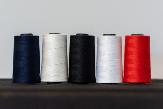 Coats astra polyester threads in black, blue, white, natural and red for sewing